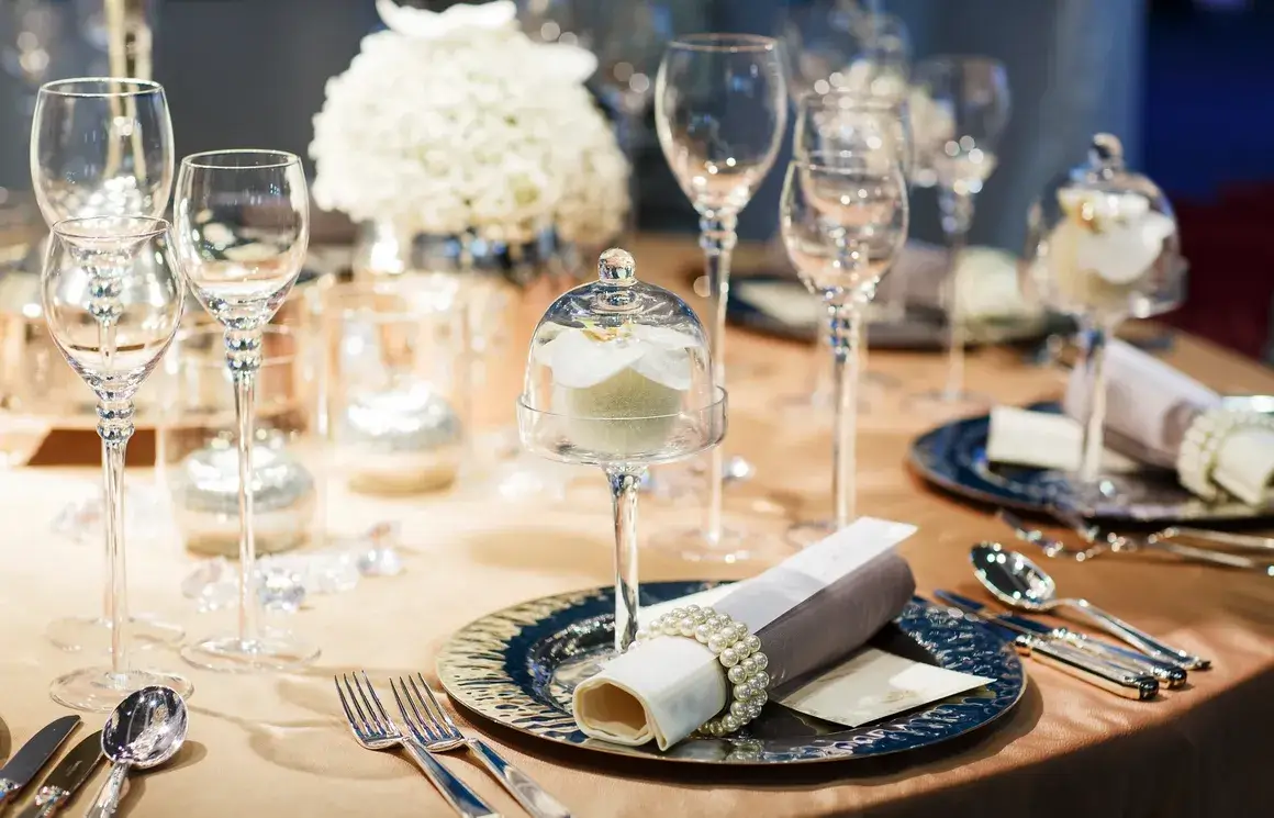 A closeup look at a dining table full of glass utensils